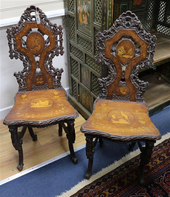 A pair of 19th century Swiss / Black Forest marquetry hall chairs